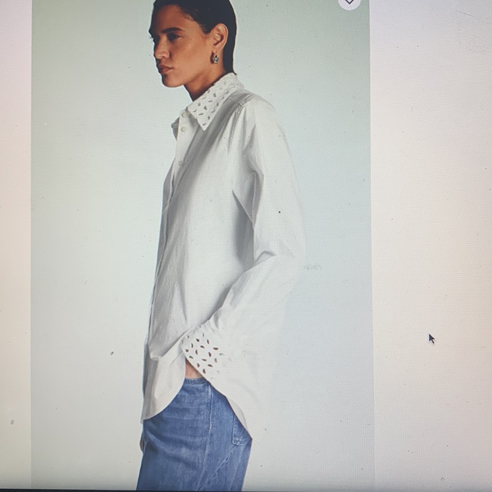 Long-sleeved cotton shirt in crisp white with intricate eyelet details.